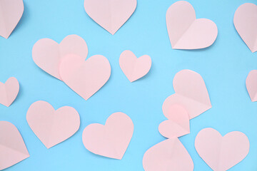 Pink paper heart on blue background. Valentine's Day celebration