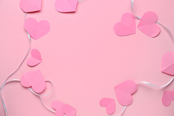 Frame made of ribbon with paper hearts on pink background. Valentine's Day celebration