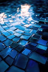 Obraz premium A blue mosaic tile pattern with a blue background. The tiles are blue and white. The tiles are arranged in a way that creates a sense of depth and movement. The image has a calming and serene mood