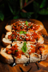 Bruschetta with Tomato Topping, Basil, and Balsamic Glaze on Wooden Serving Board in Rustic Setting  