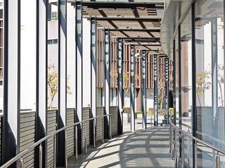 Modern architectural walkway in Tseung Kwan O, Hong Kong, China.  Sleek design with metal railings and shaded pathway.  A blend of modern and traditional elements showcasing urban design in TKO.
