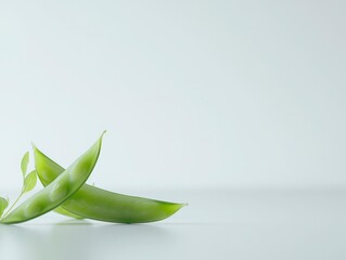 Fototapeta premium Fresh Green Pea Pods with Leaves on Minimalist Background