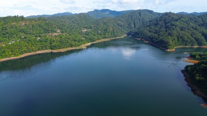 Aerial drone view of Sempor reservoir, Kebumen, Indonesia with a background of hills and trees