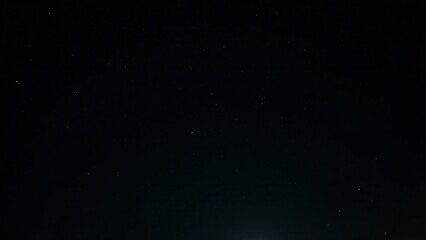 Fototapeta premium A deep black sky covered in flickering stars, creating a mesmerizing and magical starlit scene.