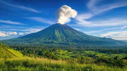 Fototapeta premium A dramatic shot of an active volcano under a clear blue sky, with white smoke rising from the crater, capturing the power and natural beauty of the eruption