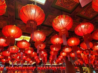Red Lanterns: A captivating ceiling adorned with numerous vibrant red lanterns, casting a warm,...