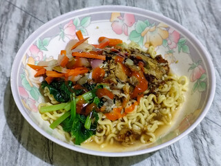 Mie, Mie ayam, mi ayam, or bakmi ayam is a common Indonesian dish consisting of seasoned yellow wheat noodles topped with chicken pieces. This dish originates from Chinese culinary techniques.