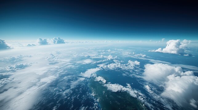 Fototapeta Aerial view of the ocean with waves and clouds seen from an airplane window