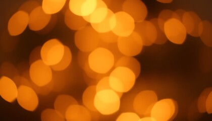 Fototapeta premium Golden bokeh lights with a warm glow, defocused circles creating a festive ambiance in soft orange and yellow tones.