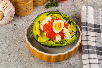 Avocado with red caviar and quil egg