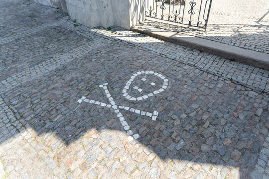 Stone laid skull with crossbones near entrance to Kostnice Sedlec cemetery in Kutna Hora in the Czech Republic