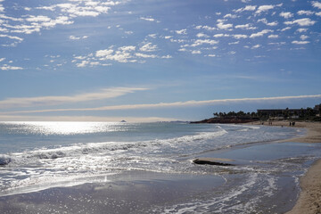 horizon on the beach, a day with high clouds and little sunshine, with a calm blue sea and white sand