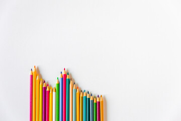 Multicolor pencils on a white background, flat lay. Rainbow pastel bright colors. Copy space for...