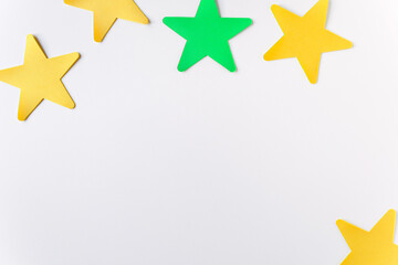 Flat lay of crafts color stars on the  white background with copy space. Kids art mockup