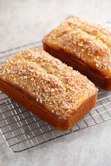 Freshly baked almond loaf cakes cooling on a rack