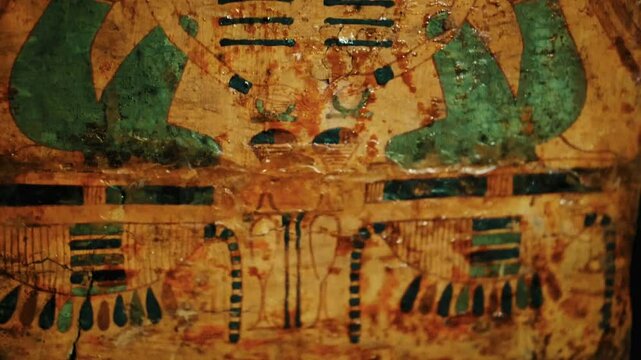 A close-up of an ancient Egyptian wall painting with intricate hieroglyphics and vibrant colors.