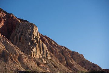 Rocky desert formations colorful red mountain with a blue sky