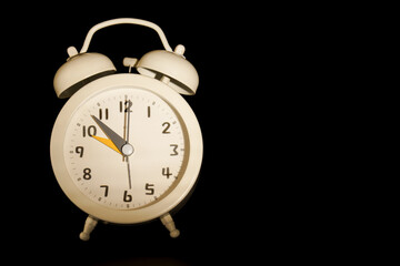 close-up of a Vintage white alarm clock isolated on a black background and copy space