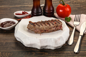 Grilled beef striploin steak with sauce