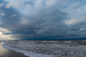 waves breaking on rocks after sunset close Palanga, Lithuania