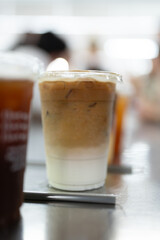 Ice cafe latte on table in coffee shop.