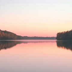 Obraz premium Calm lake reflecting pastel sunset sky.