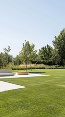 Open lawn area with modern seating and trees in a sunny landscape