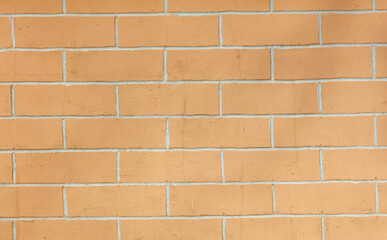 A brick wall with a tan color
