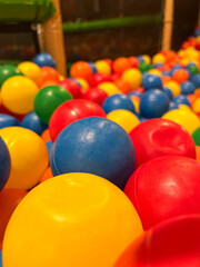 Close up of colourful plastic balls a pool at indoor playground 