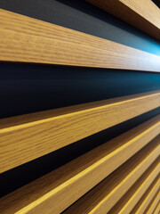 Interior wall oak slats on a black background are a little different. Side views of the lamellar wall.