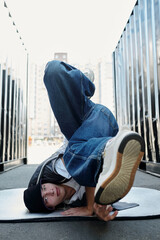 Executing Complex Breakdance Move in Urban Alleyway