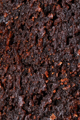 Macro texture of brownie pie. Sticky and moist chocolate sponge cake close up. Fudge cake