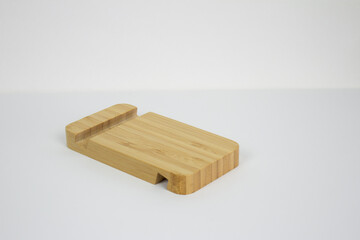 photo of a bamboo phone stand on a white background
