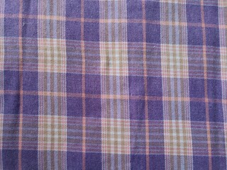 The background and fabric pattern of the checkered shirt are purple and white