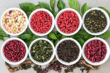 Goji berry: A powerful herbal remedy for health, Colorful bowls of herbs and dried fruits arranged on a surface.