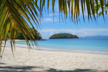 Obraz premium Beautiful tropical beach landscape with palm leaves, sand, and a blurred island in the distance. Ideal for summer vacation banners, creative designs, and backgrounds with copy space.