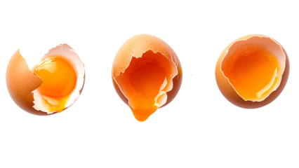 Three eggs, cracked open, yolks glowing, rich orange against black.