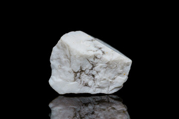 Closeup natural rough howlite gemstone on dark background (selective focus)