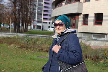 Portrait of an active elderly lady 89 years old on a walk in the city