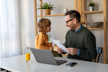 Remote business man, single parent multitasking with child at home. Productive single father online