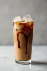 Refreshing Iced Coffee Beverage with Sweet Drizzle and Ice Cubes in a Tall Glass
