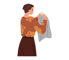Clothing and garment care concept. Housewife washing, laundrying clothes. Woman holding laundry, fabric for cleaning isolated on white background. Time for professional apparel washing, housekeping
