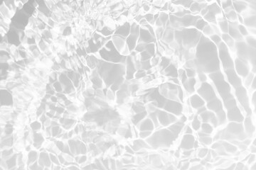White water with ripples on the surface. Defocus blurred transparent white colored clear calm water surface texture with splashes and bubbles. Water waves with shining pattern texture background.