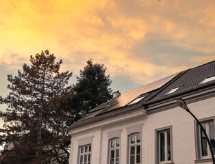 Solarpanele im Sonnenuntergang auf dem Dach eines Einfamilienhaus in Düsseldorf, Deutschland