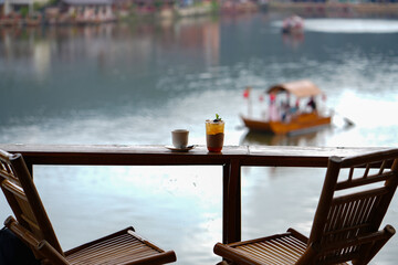 Coffee on the table and view  beside beautiful lake.