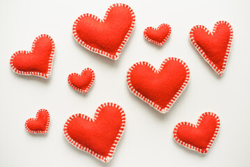 Red hearts on white background. Isolated hearts on white background. Valentine's Day background. Red felt hearts.