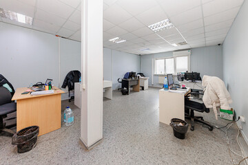 Open Canvas of Possibilities A Blank Office Space Awaits Your Vision, Bathed in Bright Fluorescence and Tiled Elegance.
