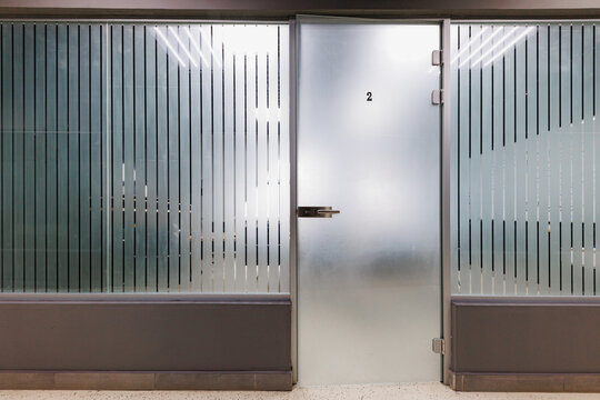 Behind the Frost A Glimpse into Room Twos Serene Spaces, Framed by Elegant Stripes in a Modern Sanctuary.