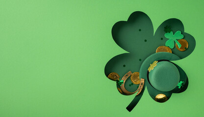 Green clover shape surrounded by a festive hat, gold coins, and thematic decor