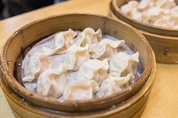 Delicious steamed pork dumplings in bamboo basket
